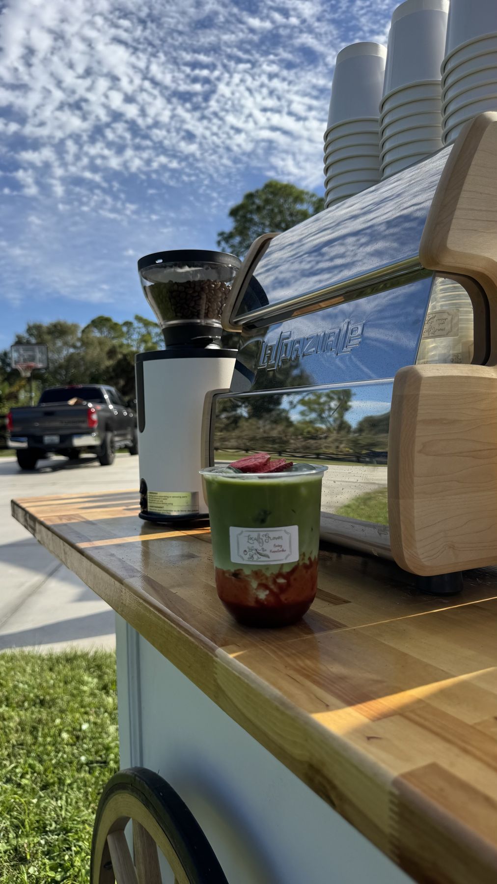 Coffee cart set up outdoors under a blue sky