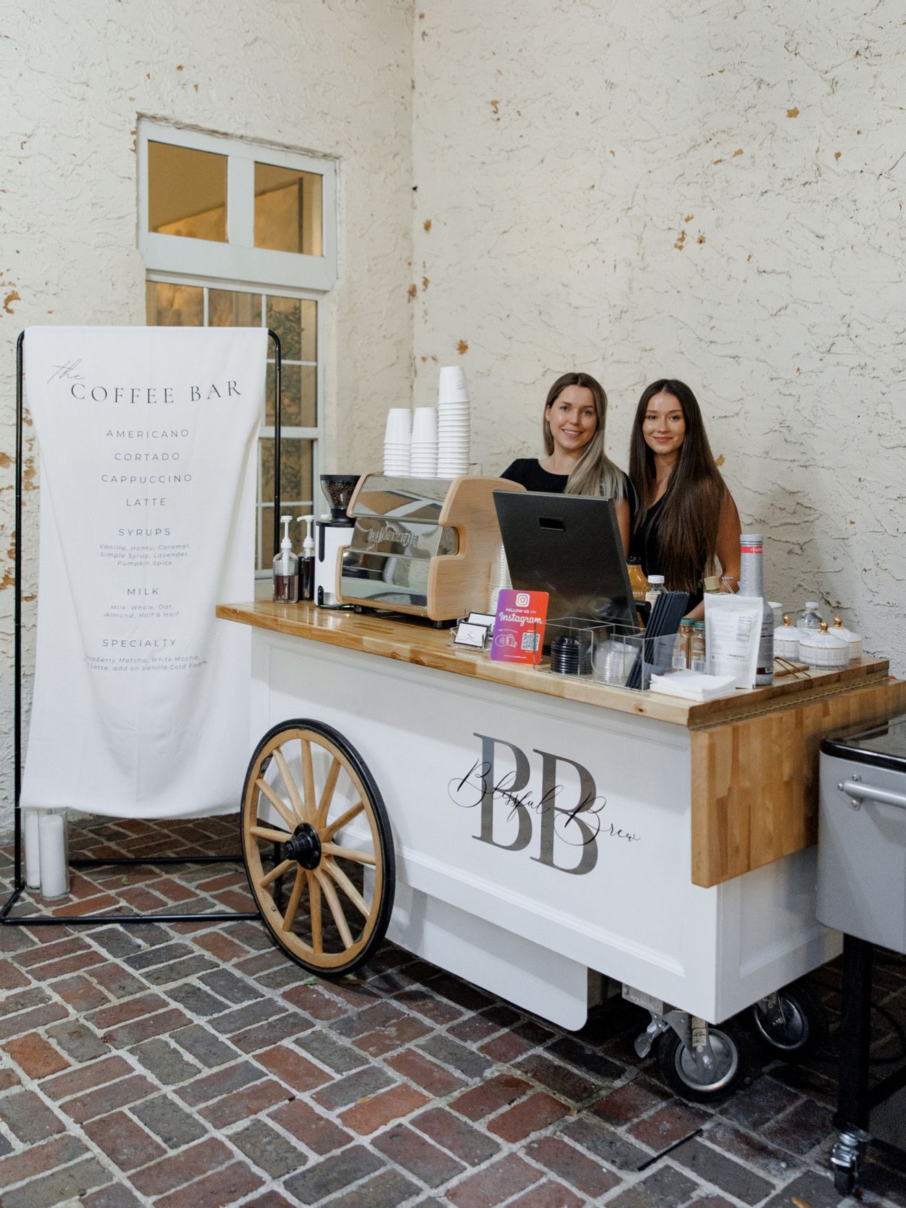 Blissful Brew baristas behind the coffee cart
