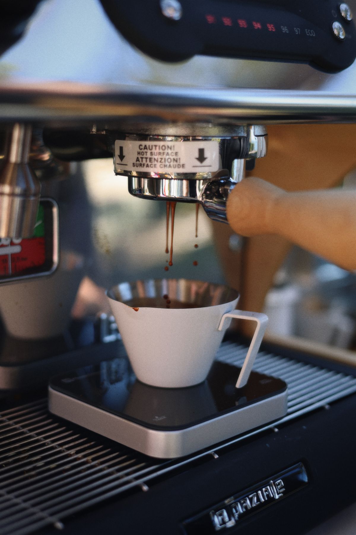Espresso shot pulling into a white cup